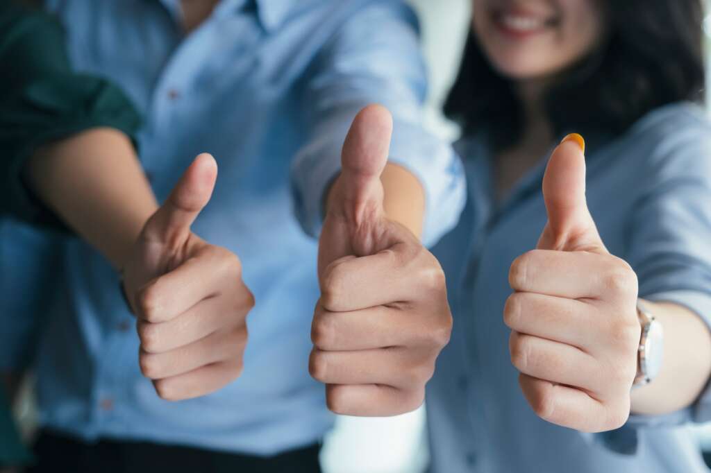 Successful business people with thumbs up and smiling, business.